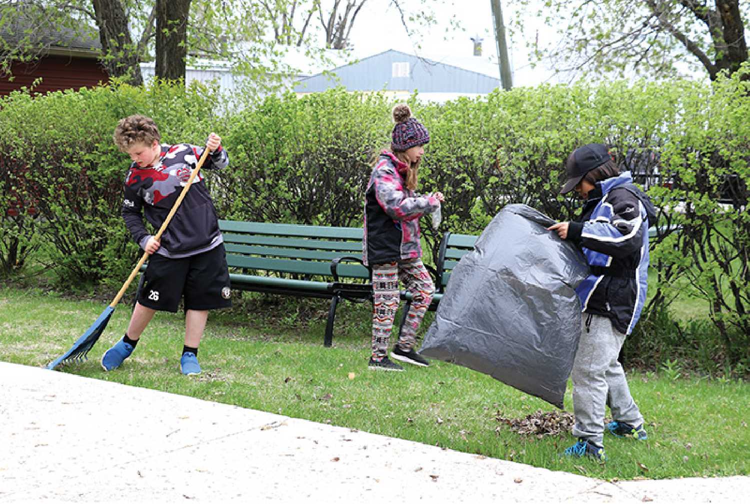 MacLeod students helping clean up Moosomin’s Cenotaph Park by sweeping leaves and picking up branches during last year’s cleanup.